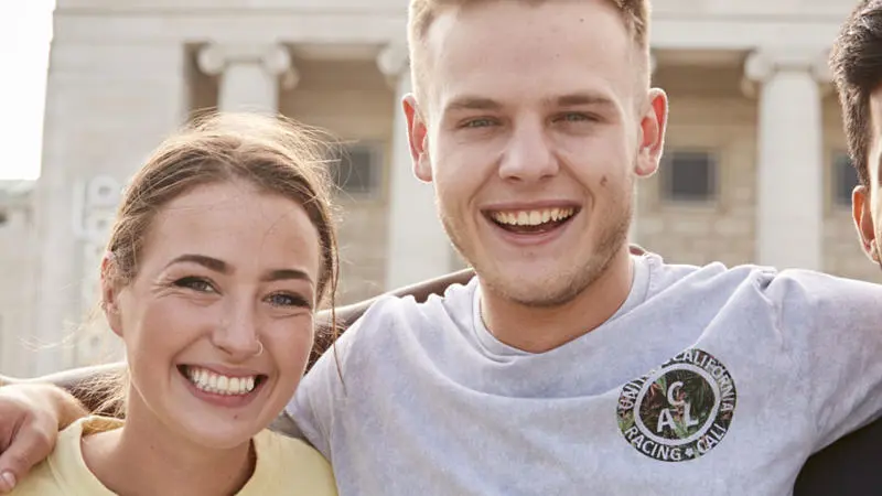 students smiling at the camera