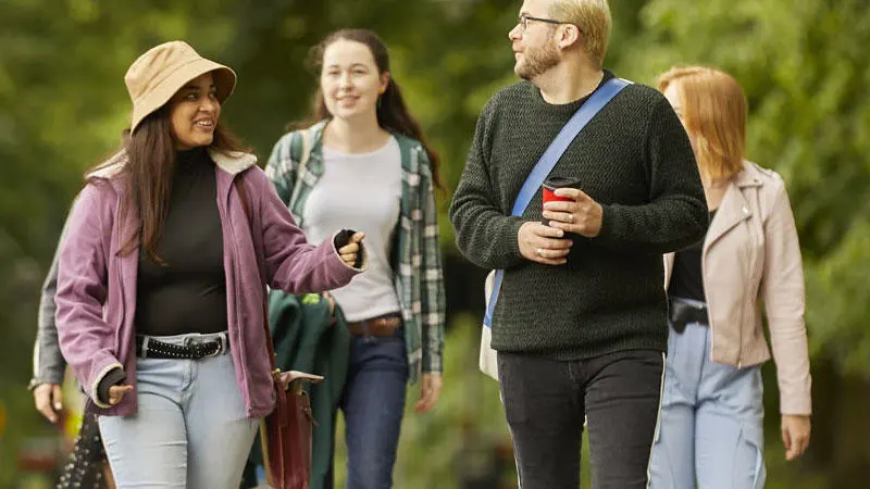 students walking through park