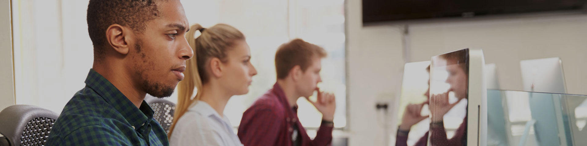 Students using Mac computers in the library