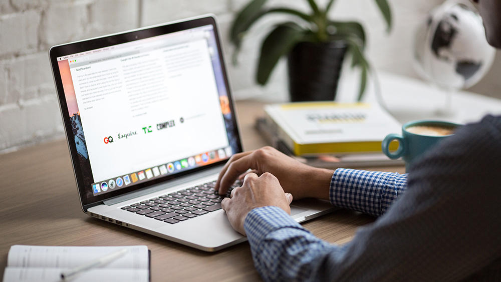 A person typing on a laptop