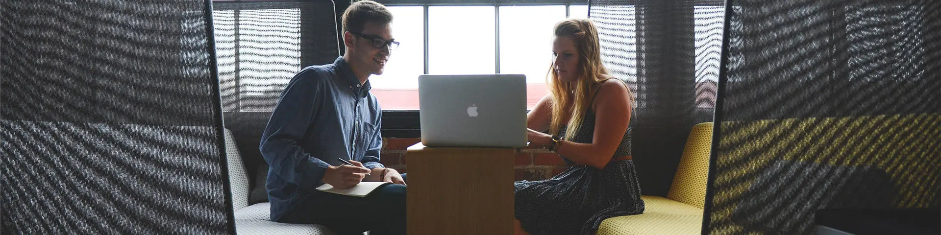 Two people sat at laptop