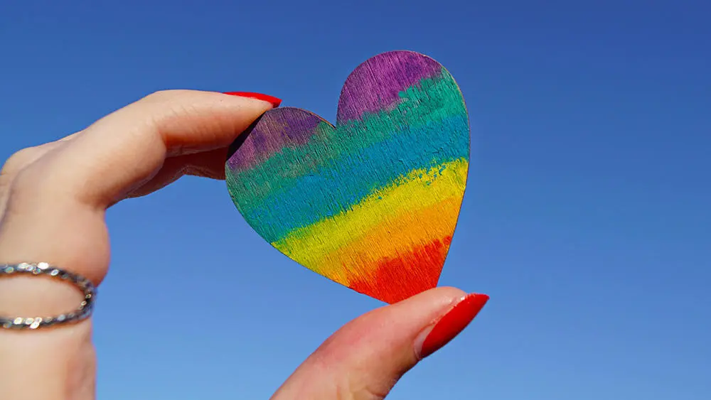 rainbow pride on heart held by lady