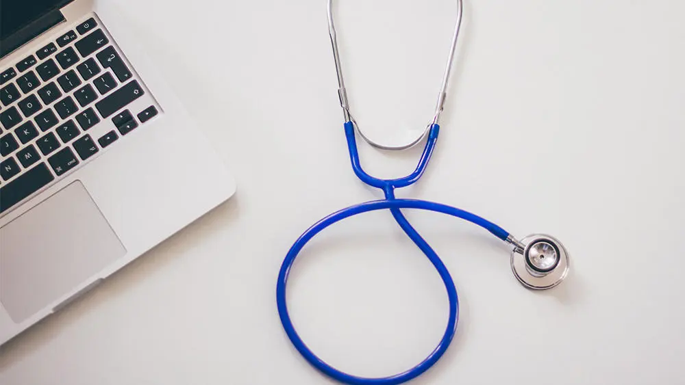 A stethoscope and a laptop