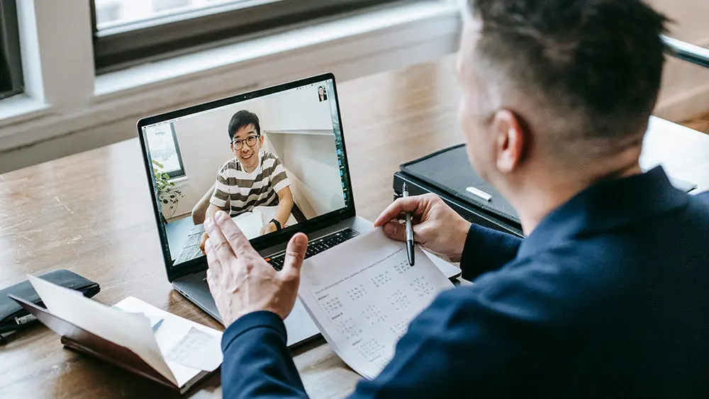 Two men on a laptop video call
