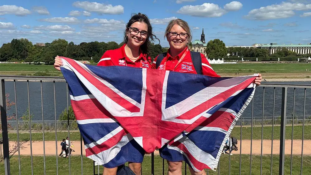 Students holding Union Jack at the Games