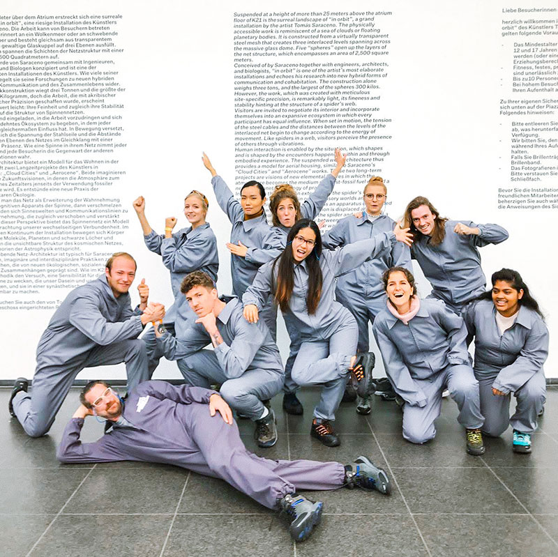 Image of a magazine article showing a group of people wearing boiler suits smiling at the camera